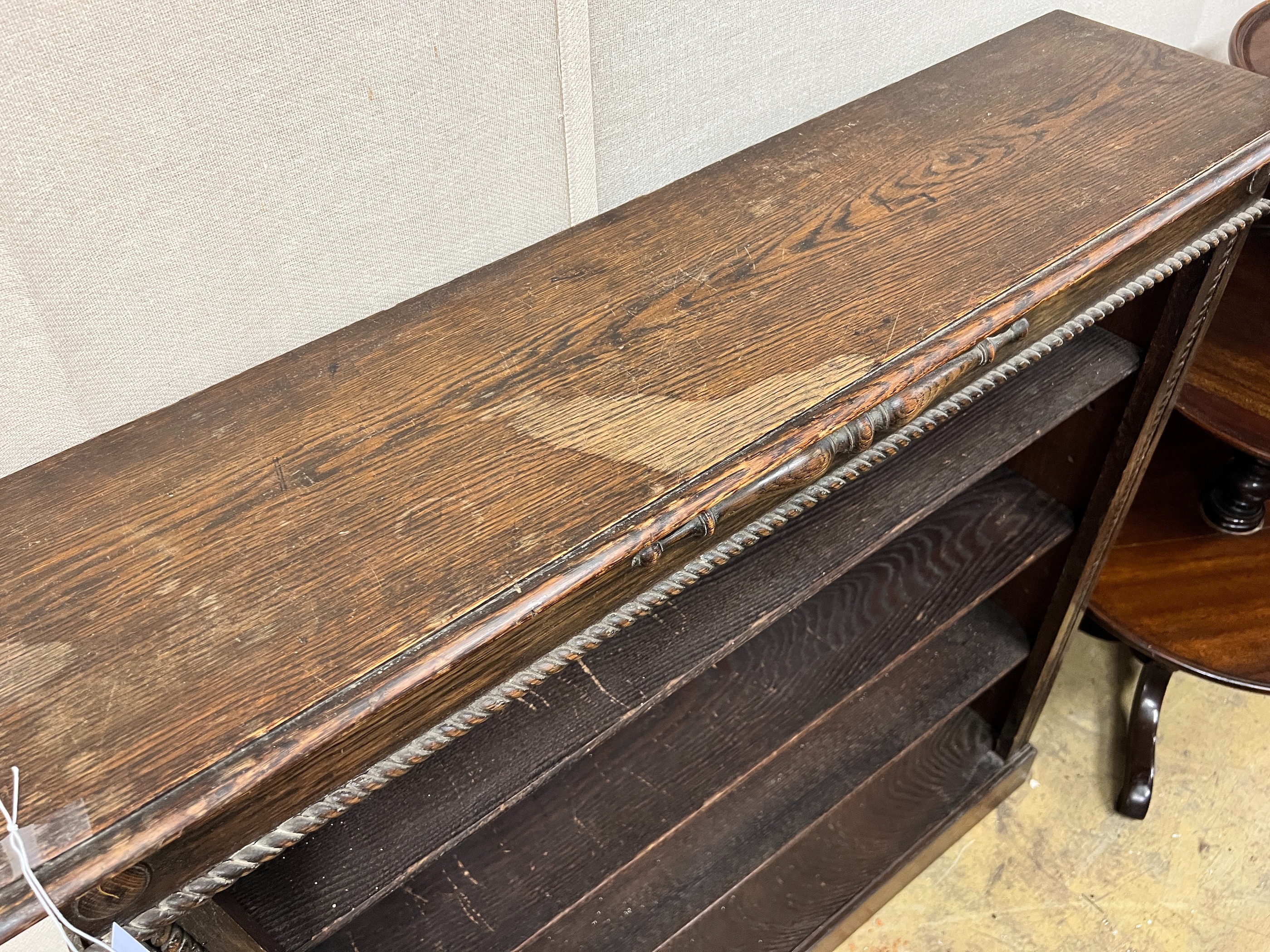 A 1920's oak open bookcase, length 99cm, depth 25cm, height 108cm